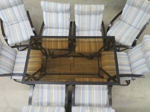 PATIO TABLE WITH 8 ROCKING CHAIRS.