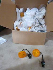 lot 103 image: Case of Peterson Manufacturing Amber Marker Lights