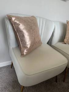 Two Graceful Ivory Accent Chairs with Metallic Rose Gold Toss Pillows