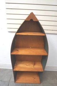 lot 28 image: wood canoe shaped bookshelf