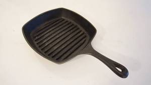 lot 212 image: 10 in. well seasoned Emeril cast iron ribbed fry pan