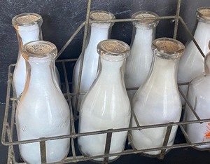 lot 101 image: Vintage Metal Milk Crate with Milk Bottles