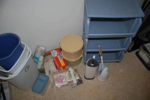 Plastic shelf on wheels, trash cans...