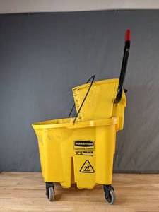 lot 79 image: Rubbermaid WaveBrake Mop Bucket with Side Press Wringer, Yellow - X