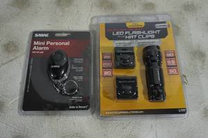 lot 83 image: Sabre Mini Personal Alarm, Cyclops LED Flashlight and Hat Clips