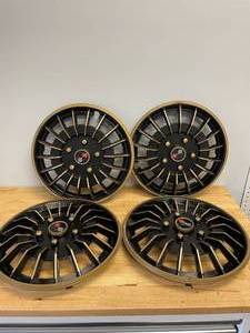 lot 73 image: Lot of 4 Decorative Plastic Hubcaps with Racing Flags