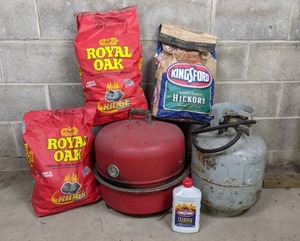 lot 41 image: Outdoor Cooking Necessities Charcoal, Lighter Fluid, Propane Tank, and Charcoal Gril