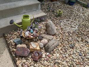 lot 188 image: A Collection of Unique Rocks, Watering Can, and Chair for your Landscaping