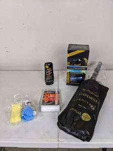 lot 195 image: Collection of New Car Care Supplies The Original Car Duster, Ultimate Liquid Wax, Quixx Paint Repair Pen, Meguiars Scratch X 2.0 Remover and Wipe New Tires Kit