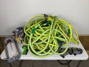 lot 182 image: Assortment of Lawn Supplies Orbit Hose Faucet Timer, Lawn Sprinkler, (4) Garden Hoses and More