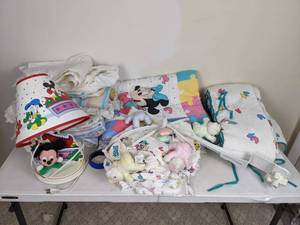 lot 216 image: Collection of Disney Themed Crib Set Up Sheets, Blankets, Lamp, Comforter, Bumpers, Mobile Jolly Jumper and More
