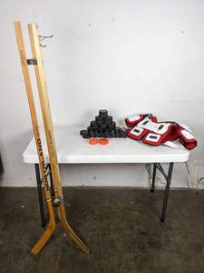 lot 348 image: Group of Hockey Pucks, Douglas Shoulder Pad and a Hockey Stick Stand