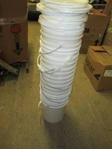 stack of 8 5 gallon buckets with l...