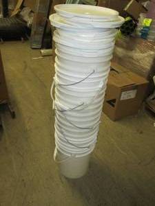stack of 8 5 gallon buckets with l...