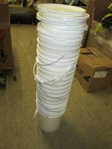 stack of 8 5 gallon buckets with l...