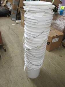 stack of 8 5 gallon buckets with l...