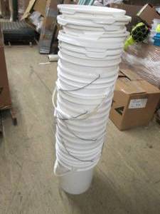 stack of 8 5 gallon buckets with l...