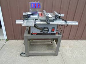 Ryobi 10 table saw with stand. Includes fence, miter & dado plate & assorted accessories. Good working condition. As shown.