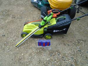 Sunjoe 110 volt lawn mower with trimming accessories. As shown.