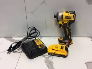 lot 19 image: ATOMIC 20-Volt MAX Cordless Brushless Compact 14 in. Impact Driver, (2) 20-Volt 1.3Ah Batteries, Charger & Bag by DEWALT Customer Returns See Pictures