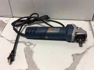 lot 77 image: 7.5 Amp Corded 4-12 in. Angle Grinder with Lock-on Slide Switch by Bosch Customer Returns See Pictures