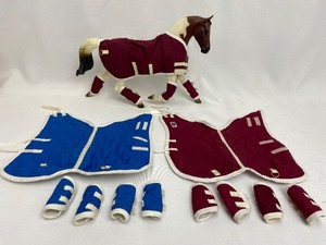 lot 32 image: Breyer - Set of FOUR Quilted Horse Blankets with Matching Socks
