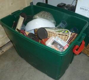 Tote full of misc items including cordless drill, battery chargers