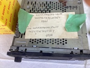 lot 73 image: Factory Volkswagen radio wVIN and code, Bosch mass air flow sensor, misc transmission plugs