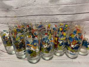 lot 108 image: A LOT OF 14 SMURF GLASSES. FROM 1983