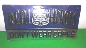 lot 505 image: Real Heroes Dont Wear Capes  Law Enforcement Metal Sign