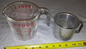 lot 642 image: Pyrex And Tin Measuring Cups.