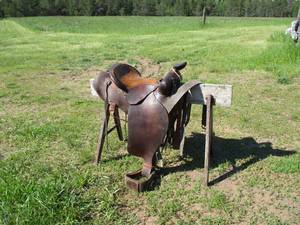 lot 64 image: Leather Horseback Riding Saddle with some tooled leather on stirrups.