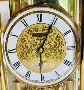 Brilliant Brass Howard Miller Clock with Etched Glass Accents