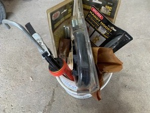 bucket of tools and hooks