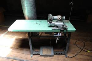 Columbia (Union Special) model 300-20 blind stitch sewing machine with motor and table.