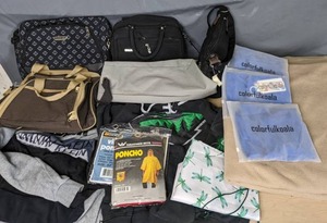 lot 150 image: An Assortment of Personal Item Includes Bags, Ponchos, Calvin Klein, Puma, and Wild Sweatshirt, Colorfulkoala, and More B