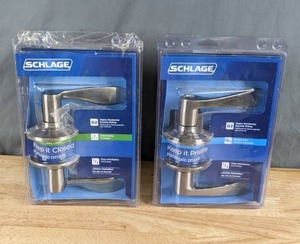 lot 246 image: New Set of (2) Schlage Accent Passage and Merano Privacy Leverset Satin Nickel Door Handles Z