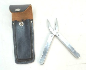 lot 181 image: American Camping multi-tool with leather belt sheath