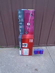 lot 105 image: Craftsman 2 cycle heavy duty straight shaft weed trimmer. Appears lightly used in the box. As shown.
