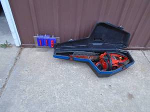 lot 119 image: Homelite chainsaw in case with earmuffs. Fires on ether. As shown.