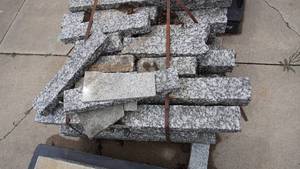 lot 3 image: Pallet of granite slabs, sizes varying with the longest measuring 36 inches  Includes pallet Skid-loader on site
