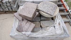 lot 6 image: Pallet of mixed granite including gray cobblestone, granite slabs, three embossed stepping stones featuring wildlife