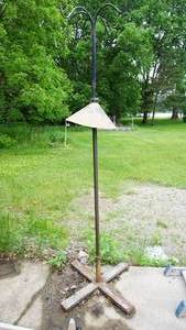 lot 11 image: Iron shepherds five hook birdfeeder with squirrel baffle on steel tripod