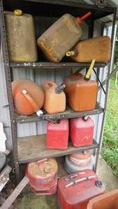 lot 14 image: Metal shelf with gas cans including vintage Eagle Snozzle gasoline can, three miscellaneous metal gas cans etc. shelf included