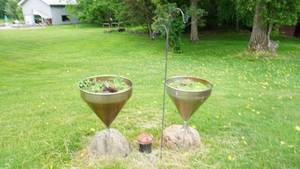 lot 37 image: EyeCatching  Set of two stainless steel Still plantersfeeders, shepherds hook