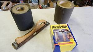 lot 76 image: Woodworkers sanding lot including one large roll 100 grit sandpaper, one large roll 80 grit sandpaper, handheld sander, horsepower handy clamp NIB