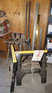 lot 161 image: Mancave garage necessities including sawhorses, rolling rack accessories gold plated steel bars, steel poles etc.