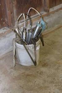 lot 16 image: Bucket of grease guns