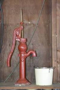 lot 90 image: Small tin bucket and water pump