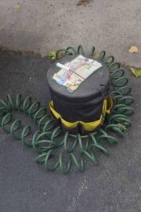 lot 108 image: garden hose and bucket seat with contents